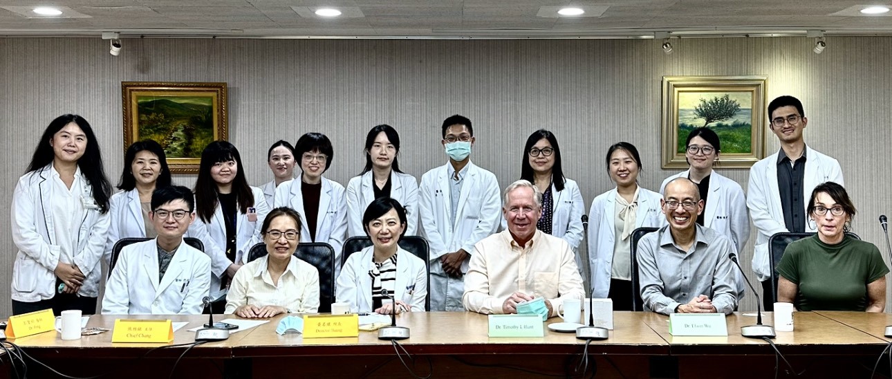 A group of doctors smiling at the camera at a table