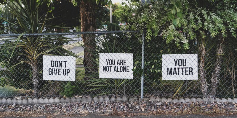 signs saying don't give up, you matter, you are not alone
