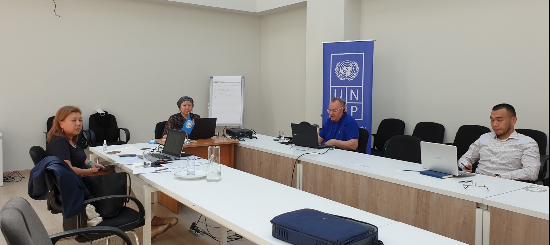 Conference organizers administering Zoom at the UNDP office in Bishkek table with conference organizers