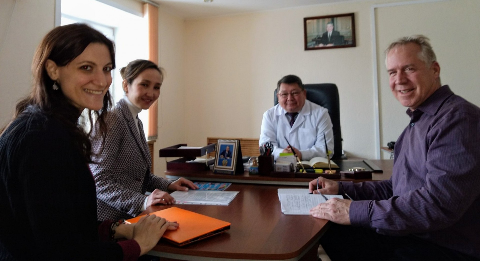 New York Project Director Tara McCrimmon (far left), KZ project Director Meruyert Darisheva, co-Investigator Dr. Timothy Hunt (far right) with Chief Doctor of the Karaganda oblast AIDS Center Beibut Sagimbayev in 2018. Bridge staff sitting around a table