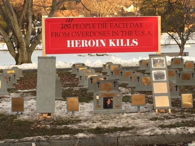 graveyard with people and sign heroin kills