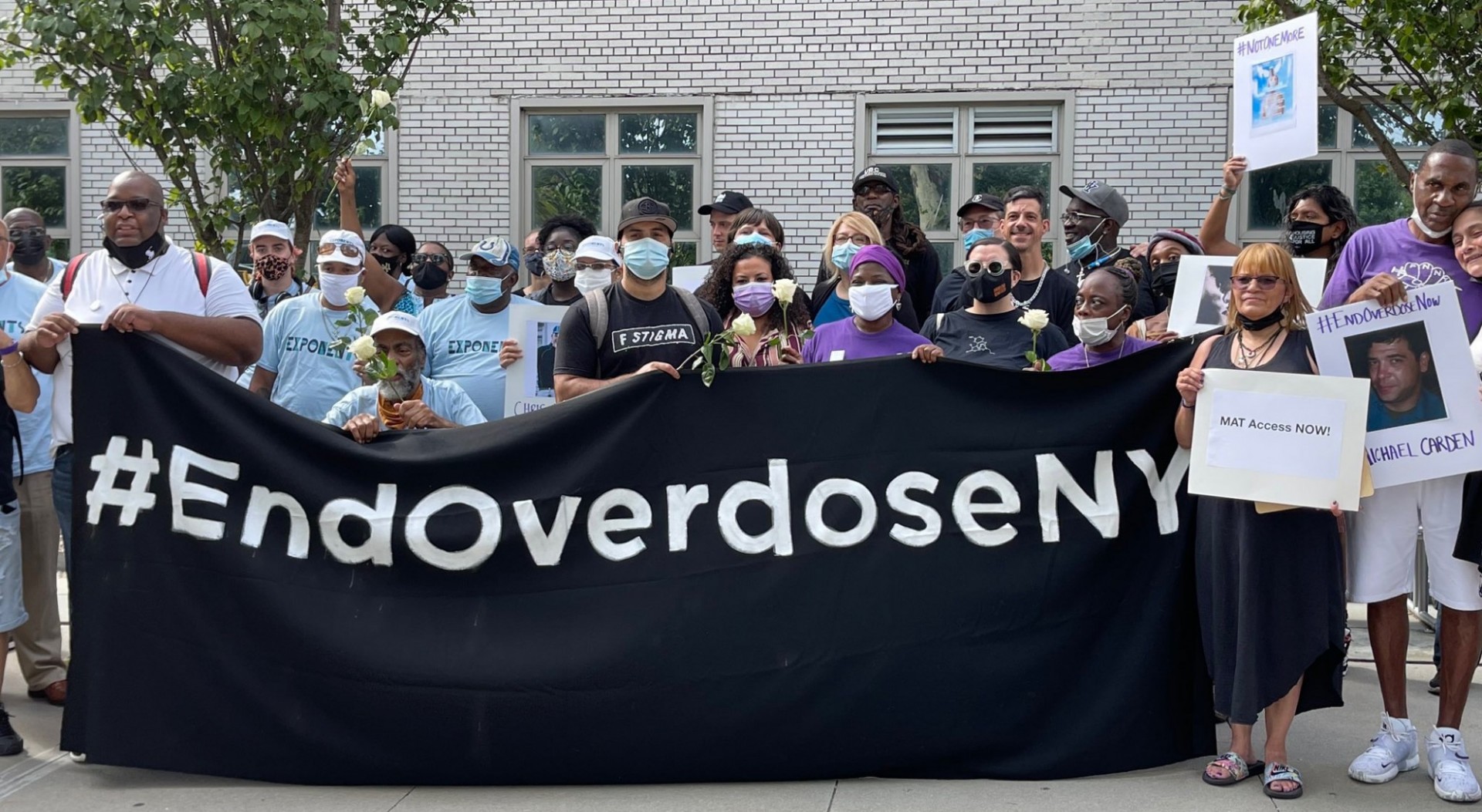 Group standing behind end overdose sign 