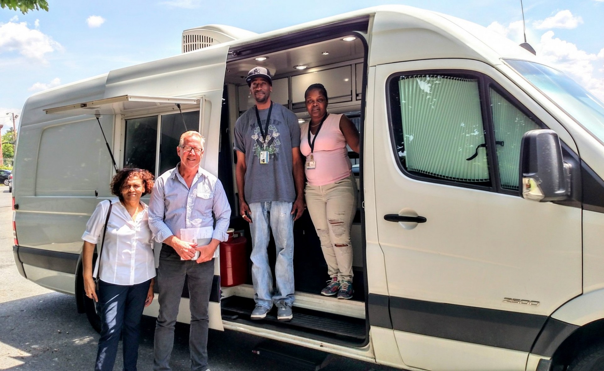 Mobile syringe van with workers and SIG outside it