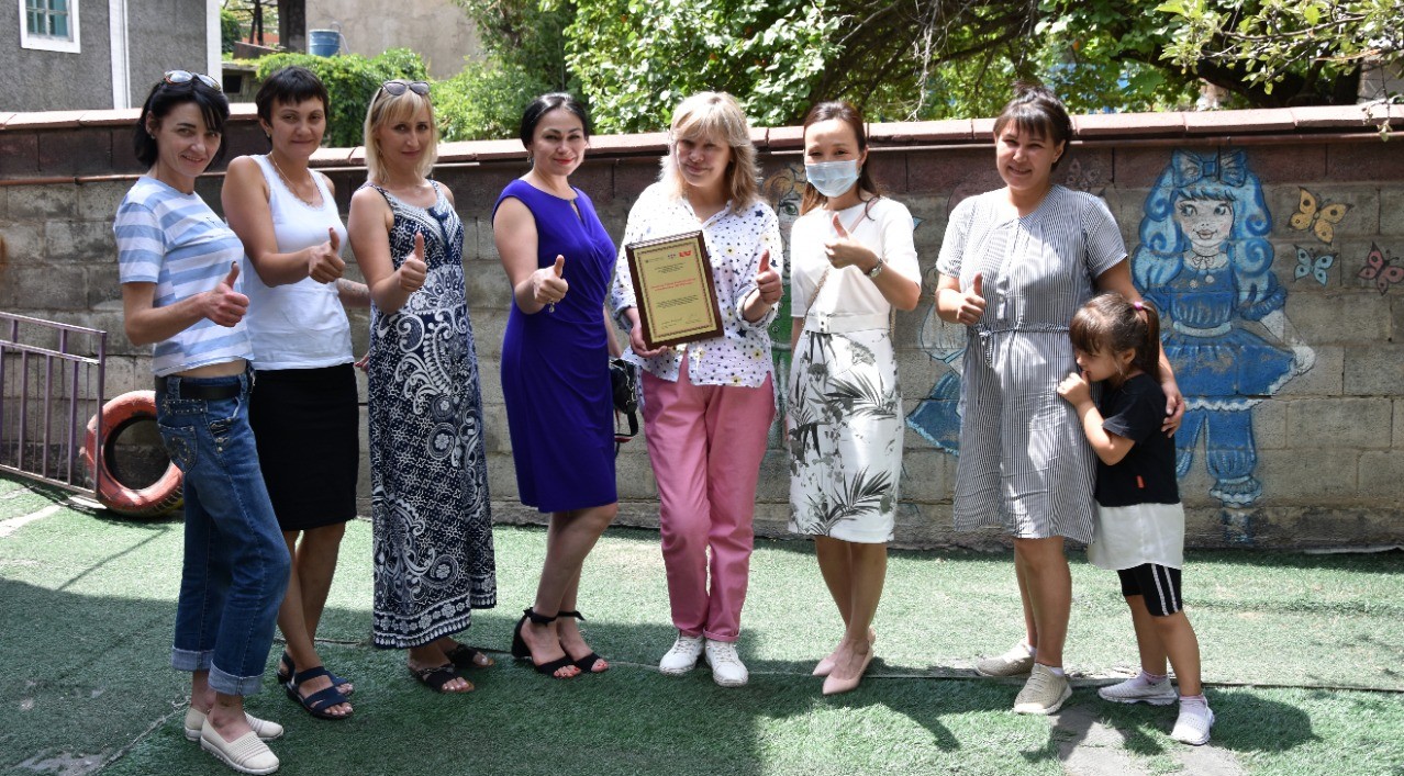 NGO “Revansh,” head of NGO Elena Bilokon and team of NGO “Revansh” with GHRCCA team. Several people outside holding the certificate