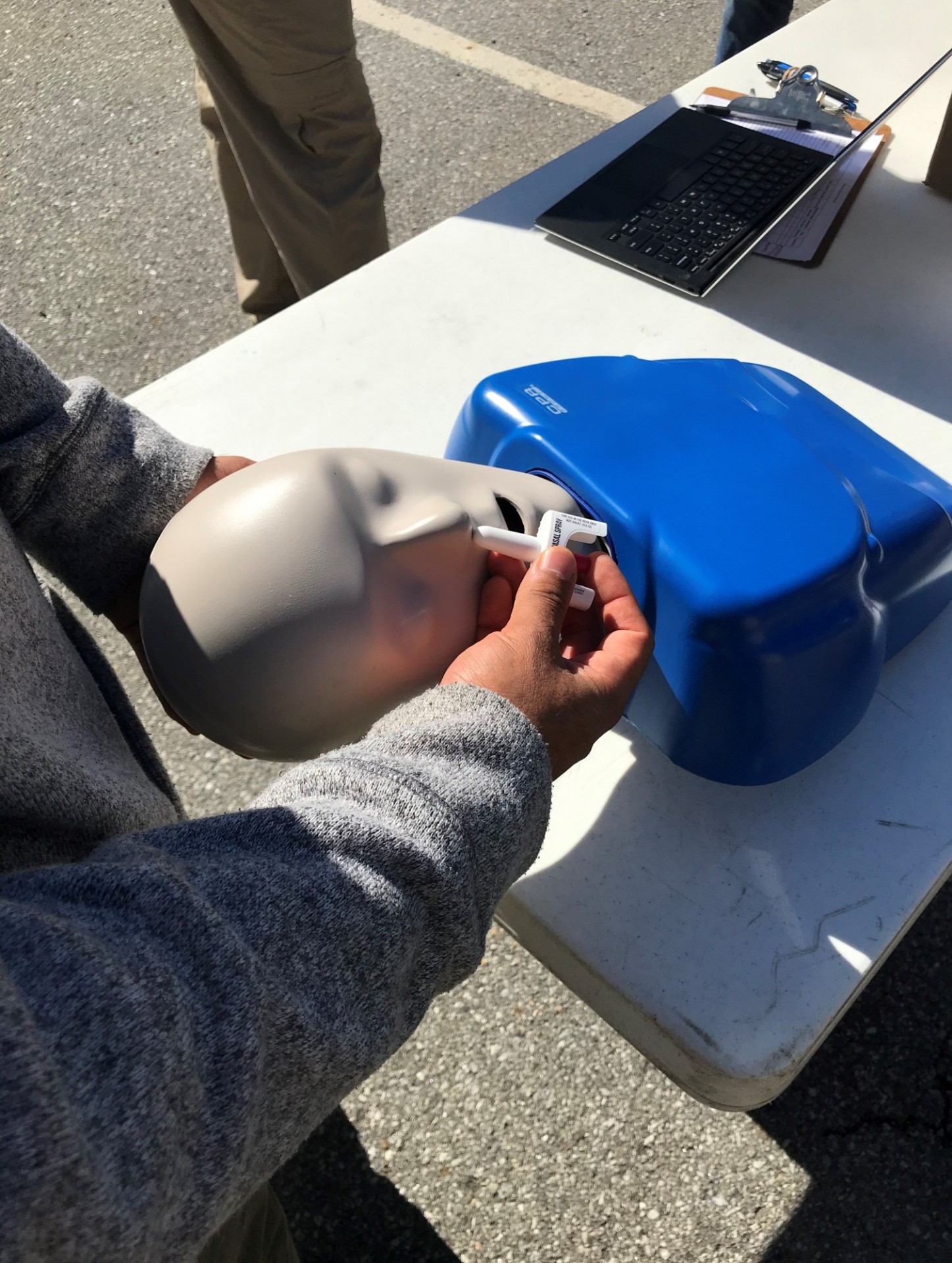 SSGT Luis Giron of the National Guard demonstrates how to administer Narcan to Dan the Dummy