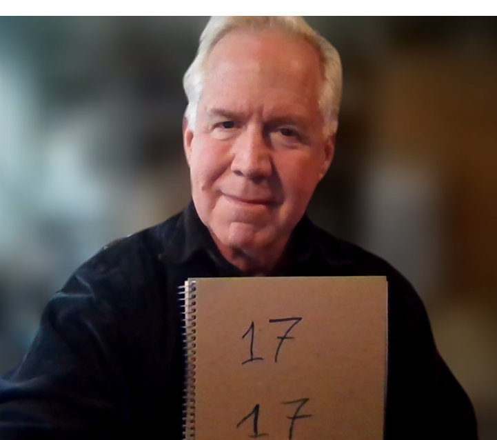 Timothy Hunt holding a piece of paper with 17 on top of another 17