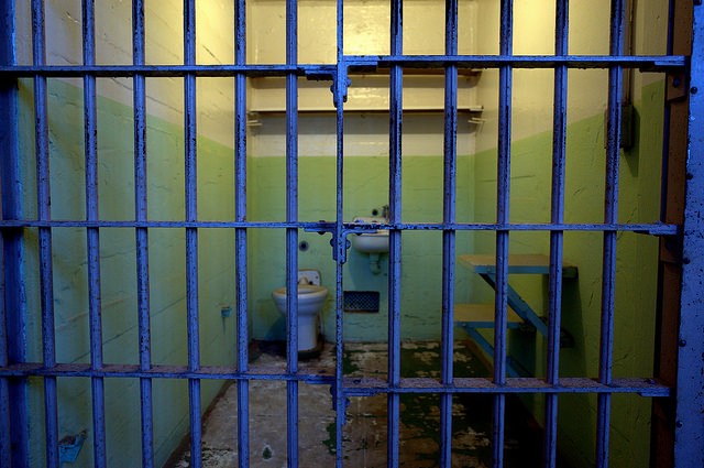 empty jail cell with dirty toilet and sink