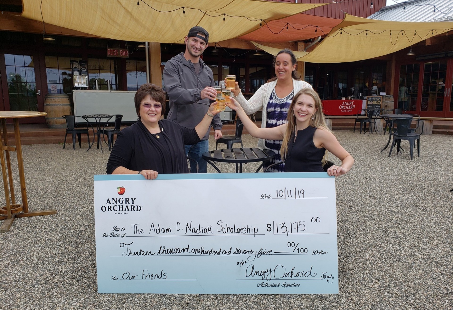 Jillian and her mother Lisa pose with a representative of the Ulster Community College Foundation and second-year scholarship recipient after accepting a donation from Angry Orchard. Jillian with Angry Orchard staff and check for scholarship fund