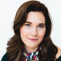 A woman with brown hair smiling at the camera