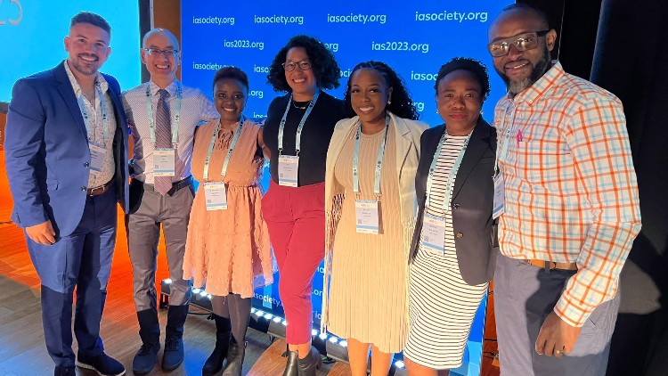From left to right: Omar Martinez, Elwin Wu, Caroline Kingori, Jiah Craddock, Megan Threats, Melanie Walcott, Peter Memiah. Photo courtesy of Caroline Kingori. A group of people smiling at the camera.