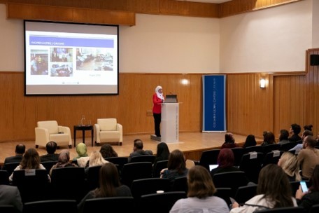 photo of a woman presenting in a large room 
