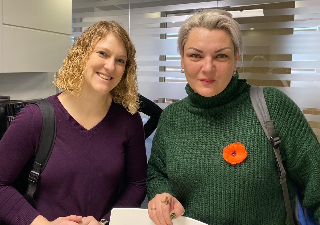 The two woman standing together inside