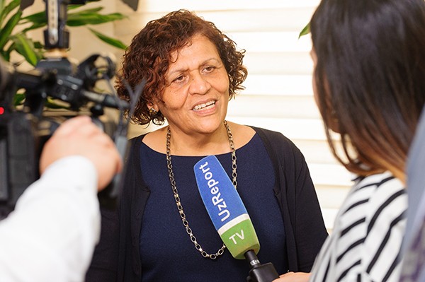 woman being asked question by media