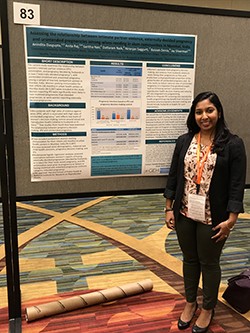 woman standing next to presentation board