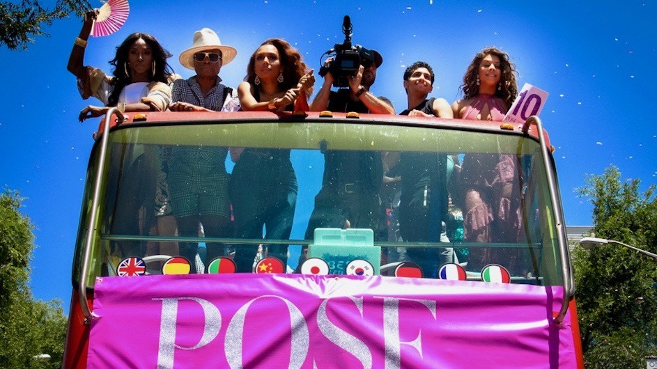 people riding a large bus with "Pose" on the front in sunny California PRIDE
