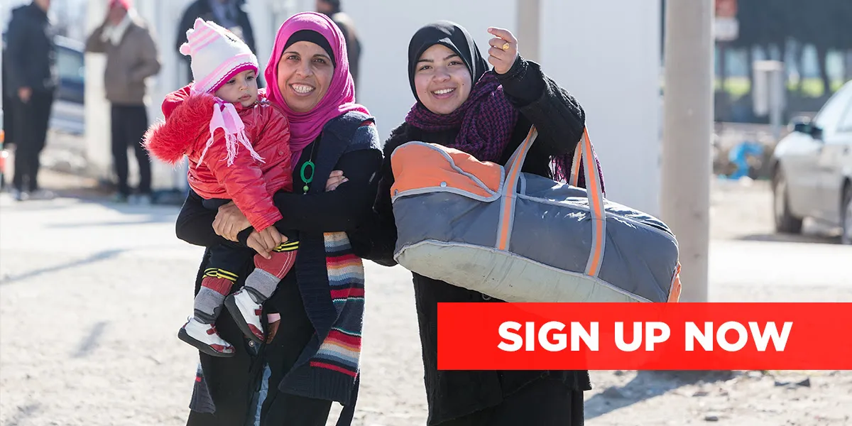 Two Syrian women holding a baby