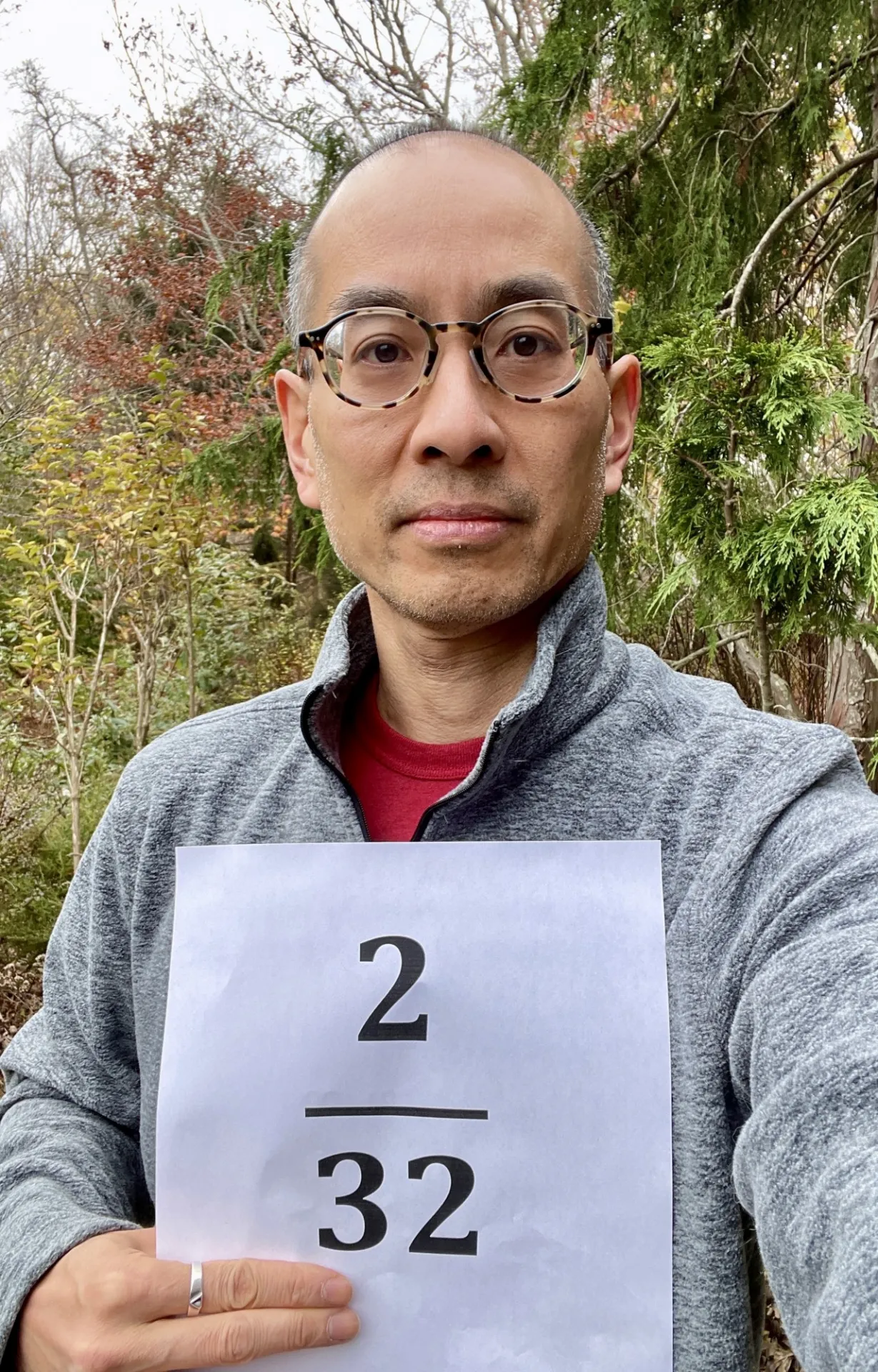 Elwin holding a paper with the fraction 2/32