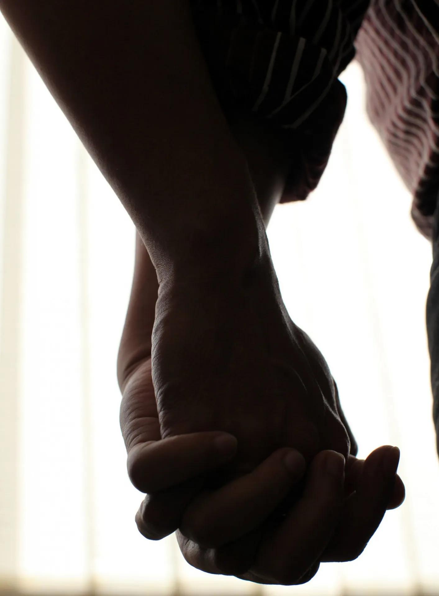 Holding hands, two black men