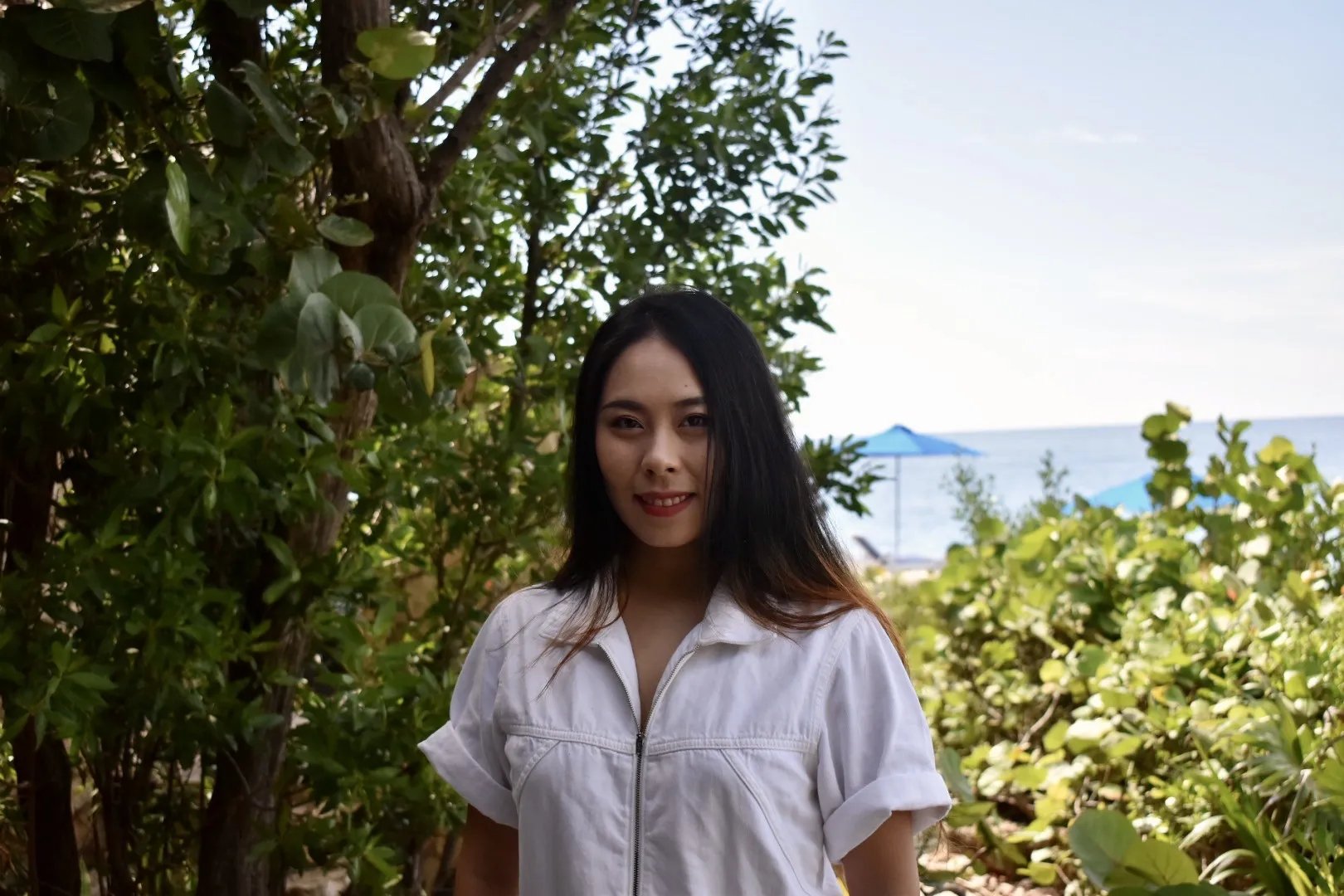 Joy in front of a tree on a warm day
