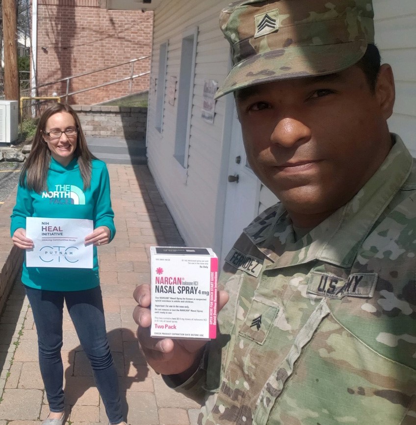 Kristin McConnell accepts a Narcan delivery from Sgt. Julio Fernandez of the National Guard Kristin McConnell accepts a Narcan delivery from Sgt. Julio Fernandez of the National Guard