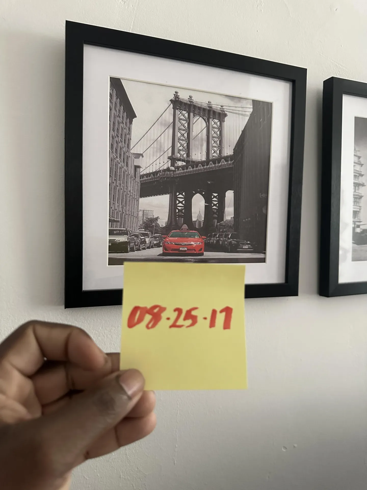 Linden holding up a post-it note with his number, 8/25/17