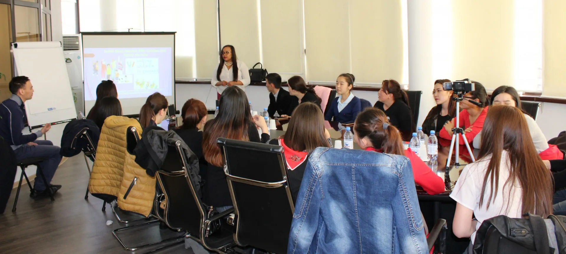 Student teaching a room full of others in Kazakhstan