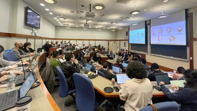 A classroom full of people taking notes on a discussion