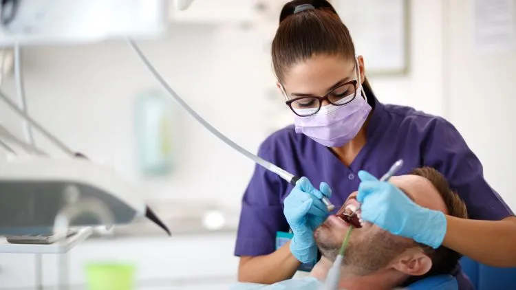 a woman doing dental care on a man