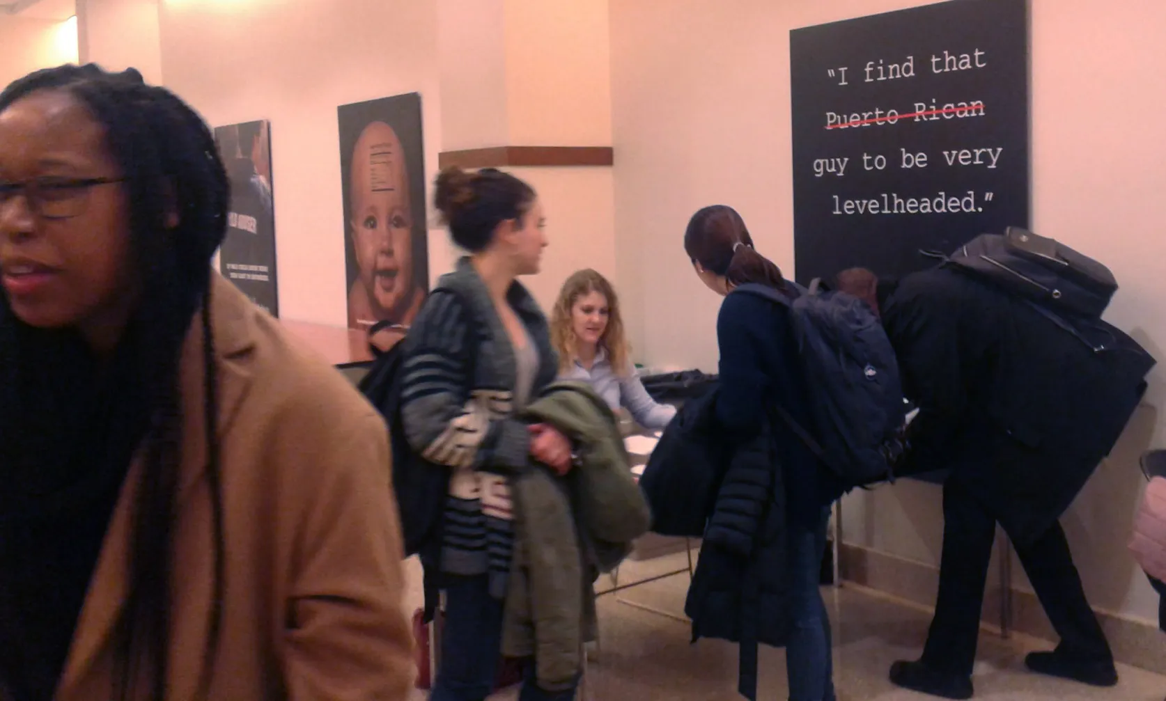 The registration table staffed by Alissa Davis (next to a sign providing an instructive teaching moment)   Photo credit: Eleni Vlachos of the Social Intervention Group