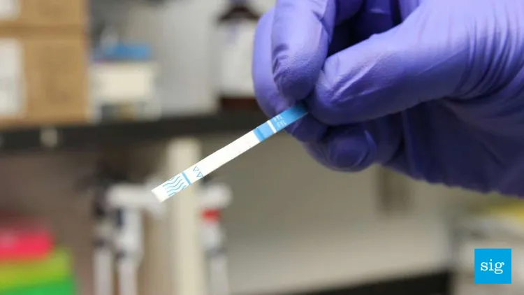a fentanyl test strip being held in a hand