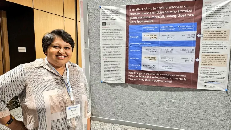 a woman standing in front of a large poster with a lot of text