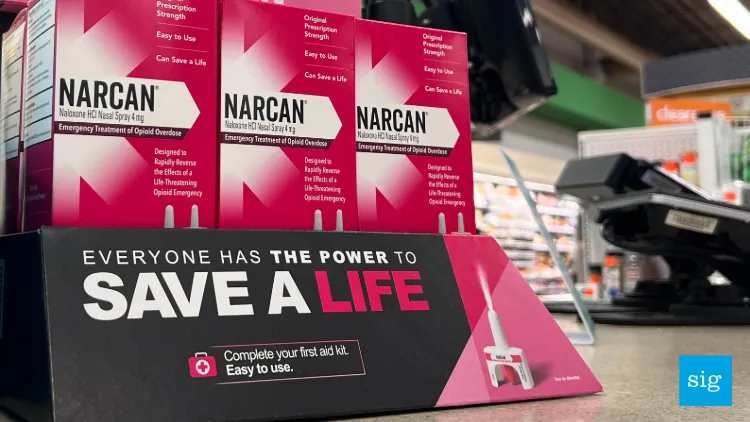 a display of boxes of narcan at a cash register in a store