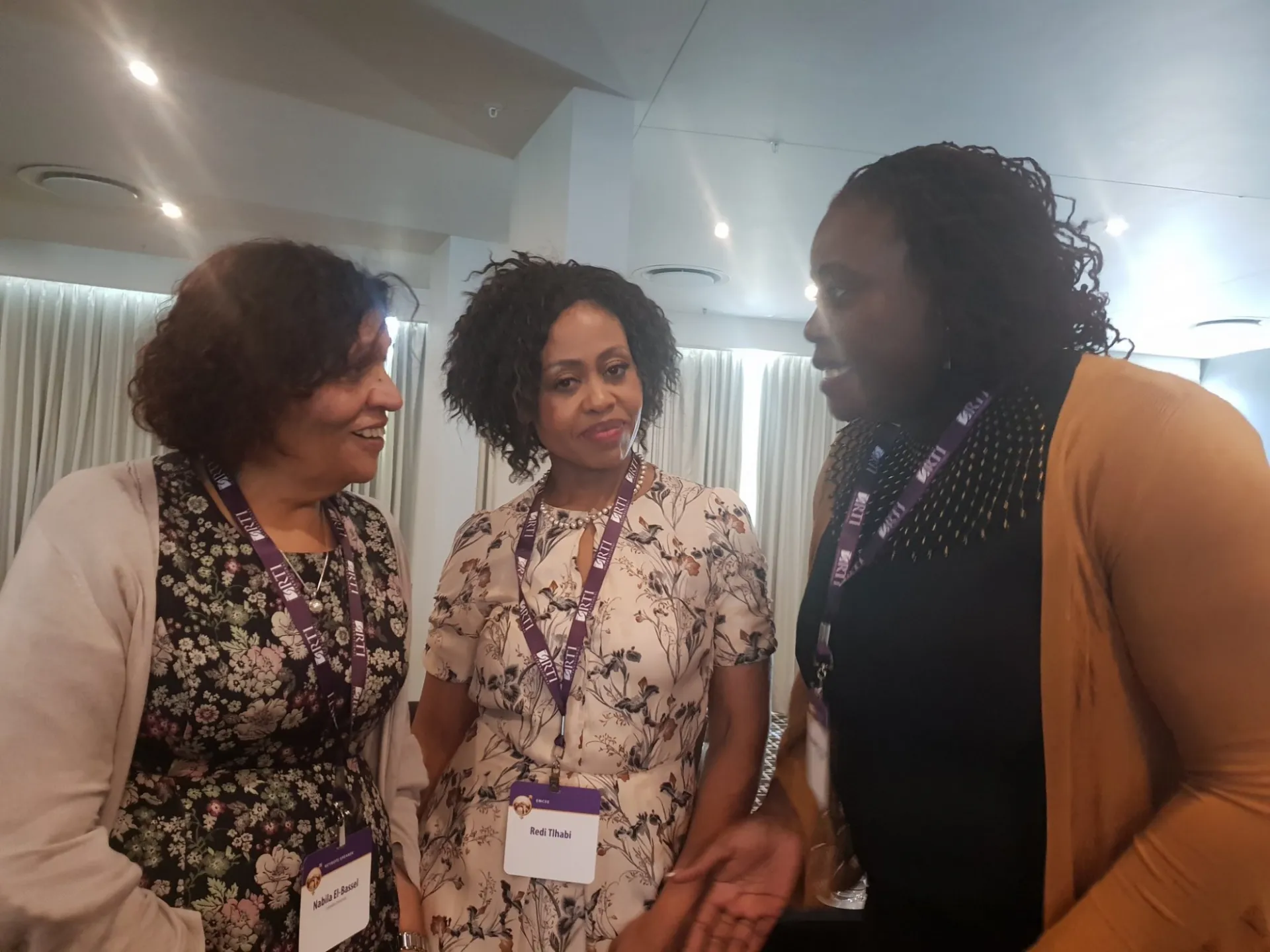 Photo of three women at the RTI conference