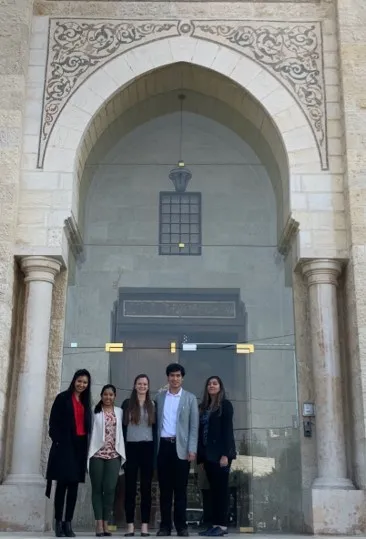 ASPIRE team in front of a big ornate building with columns