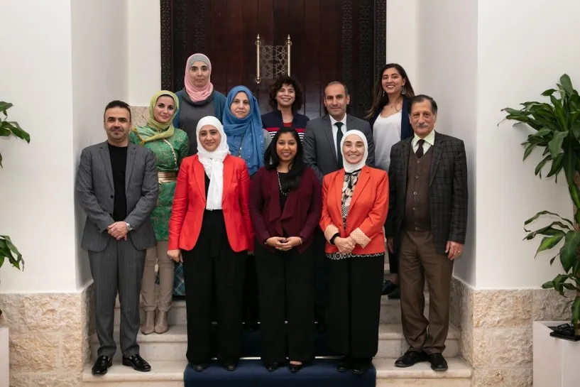students and ASPIRE in front of an ornate wooden door