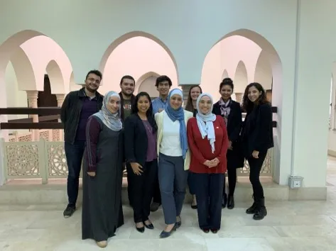 students and ASPIRE in front of beautiful building with multiple white archways