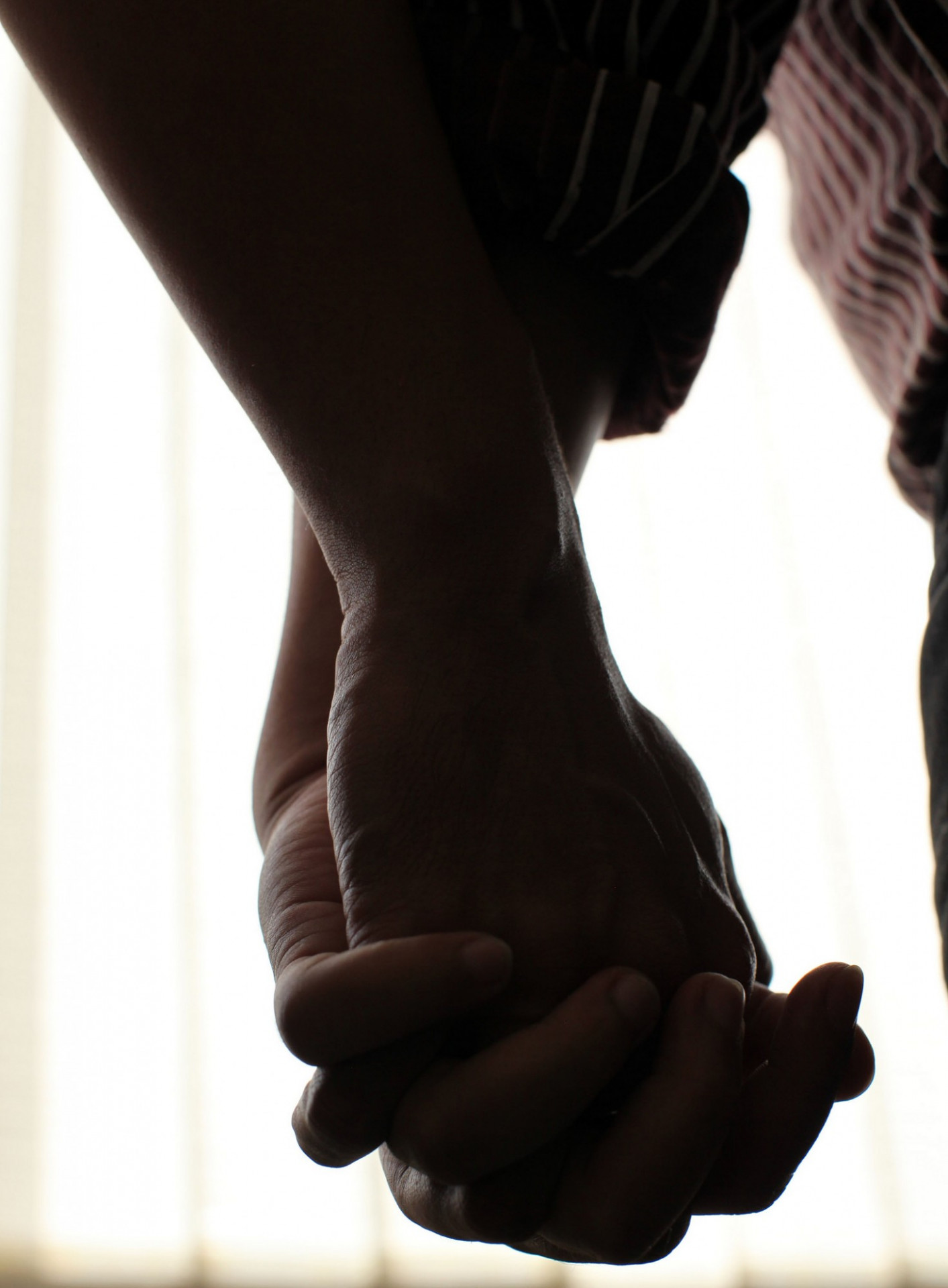 two men holding hands