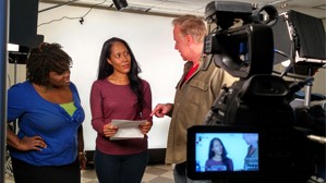 people next to teleprompter