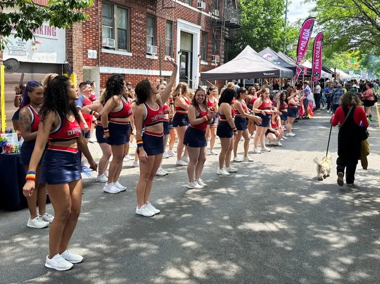 Cheerleaders in red tops and blue skirts performing