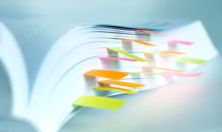 book with post-it notes sticking out of the pages