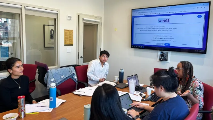 students learning with screen in the background