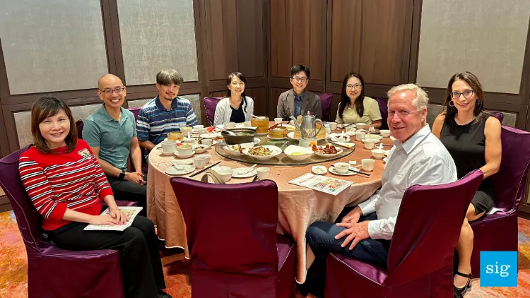 a group of people sitting around a table