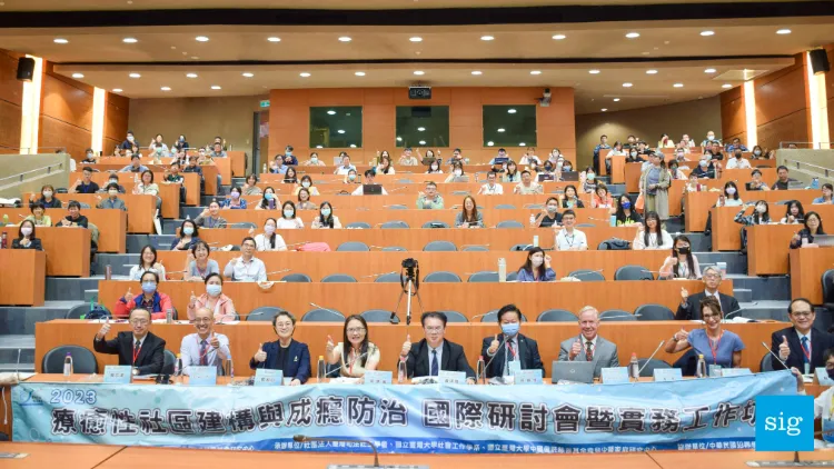 panel at conference with audience behind