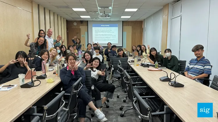 a group of students and sig staff in a room