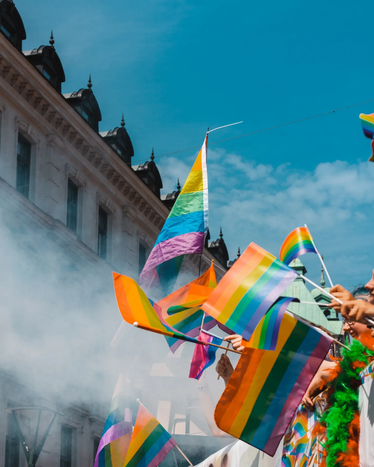 pride flag in the sky with smoke