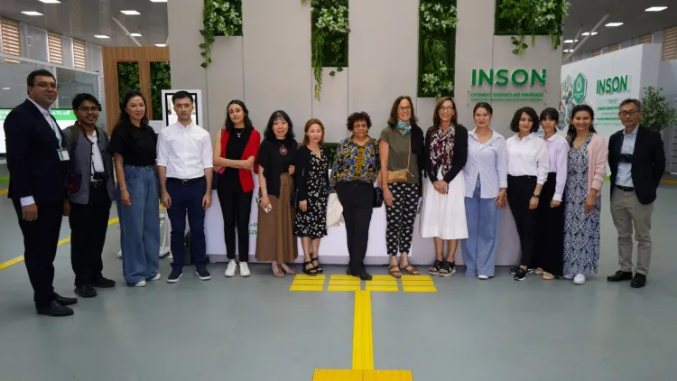 A group in front of the logo for a local organization.